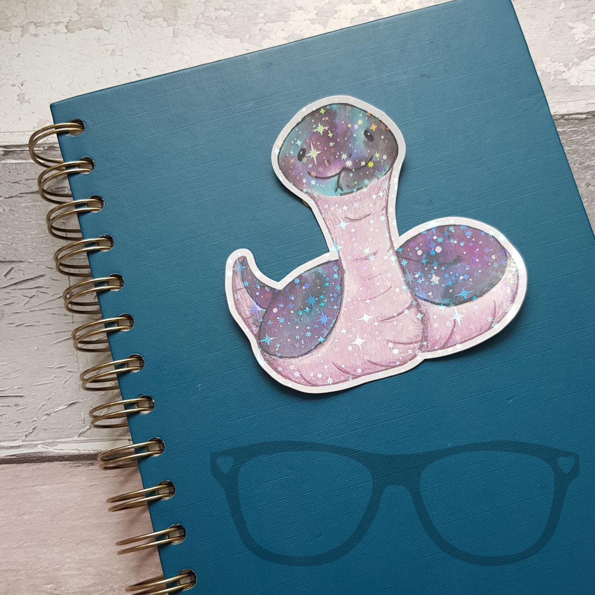 Snake vinyl sticker with star sparkle on notebook