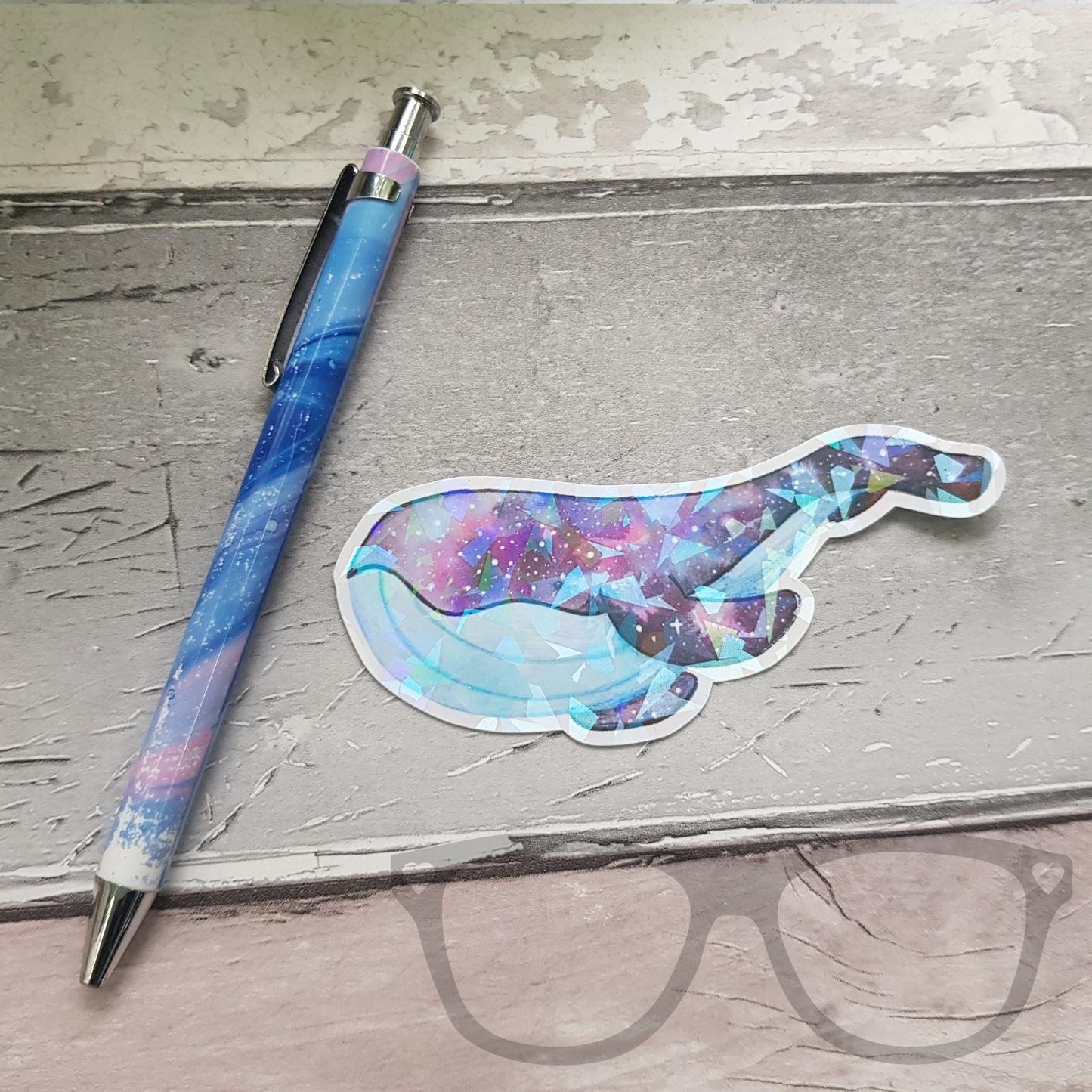 Sparkling Space whale sticker next to a pen to show scale